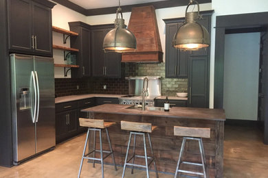 Enclosed kitchen - mid-sized rustic l-shaped gray floor and concrete floor enclosed kitchen idea in Other with shaker cabinets, an island, a farmhouse sink, blue cabinets, wood countertops, subway tile backsplash, stainless steel appliances, brown countertops and metallic backsplash