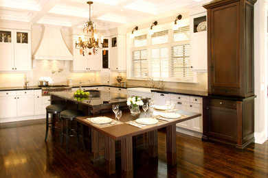 Example of a transitional eat-in kitchen design in Toronto with recessed-panel cabinets, white cabinets and white backsplash