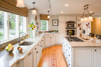 Example of a large transitional light wood floor eat-in kitchen design in Boston with white cabinets, beige backsplash, stainless steel appliances, an island, shaker cabinets and an undermount sink