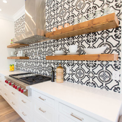 Example of a large transitional galley medium tone wood floor and gray floor eat-in kitchen design in Phoenix with a double-bowl sink, white cabinets, stainless steel appliances, an island, recessed-panel cabinets, multicolored backsplash, quartz countertops, cement tile backsplash and white countertops