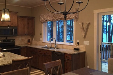 Mid-sized mountain style l-shaped open concept kitchen photo in Other with an undermount sink, recessed-panel cabinets, granite countertops, beige backsplash and an island