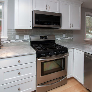 Mid-sized transitional eat-in kitchen remodeling - Eat-in kitchen - mid-sized transitional u-shaped light wood floor and brown floor eat-in kitchen idea in Boston with a single-bowl sink, flat-panel cabinets, white cabinets, granite countertops, gray backsplash, subway tile backsplash, stainless steel appliances, a peninsula and white countertops