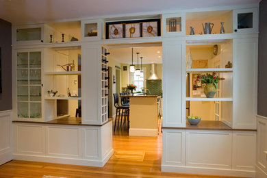 Example of a large transitional u-shaped medium tone wood floor eat-in kitchen design in Boston with shaker cabinets, white cabinets, wood countertops, green backsplash, ceramic backsplash, stainless steel appliances, an island and a double-bowl sink