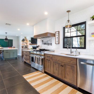 Mid-sized transitional galley ceramic tile and gray floor open concept kitchen photo in New York with an undermount sink, shaker cabinets, medium tone wood cabinets, quartz countertops, white backsplash, ceramic backsplash, stainless steel appliances, an island and white countertops