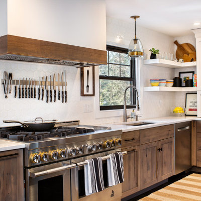 Inspiration for a mid-sized transitional l-shaped ceramic tile and black floor open concept kitchen remodel in New York with an undermount sink, shaker cabinets, medium tone wood cabinets, quartz countertops, white backsplash, ceramic backsplash, stainless steel appliances, an island and white countertops