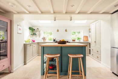Design ideas for a medium sized rural u-shaped kitchen in Cardiff with shaker cabinets, beige cabinets, integrated appliances, porcelain flooring, an island, beige floors and beige worktops.