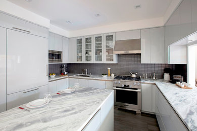Inspiration for a large contemporary u-shaped porcelain tile and brown floor enclosed kitchen remodel in New York with an undermount sink, flat-panel cabinets, gray cabinets, quartzite countertops, gray backsplash, stone tile backsplash, stainless steel appliances, an island and multicolored countertops