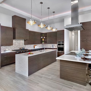 This is an example of a large contemporary l-shaped kitchen with an undermount sink, flat-panel cabinets, dark wood cabinets, quartzite benchtops, multi-coloured splashback, mosaic tile splashback, stainless steel appliances, porcelain floors, multiple islands and beige floor.