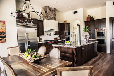 Transitional beige floor eat-in kitchen photo in Phoenix with brown cabinets, stainless steel appliances and an island