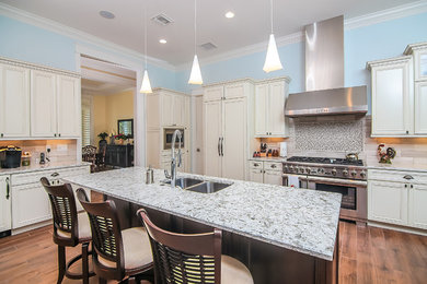 Large beach style single-wall dark wood floor eat-in kitchen photo in Miami with an undermount sink, recessed-panel cabinets, white cabinets, quartz countertops, beige backsplash, porcelain backsplash, stainless steel appliances and an island