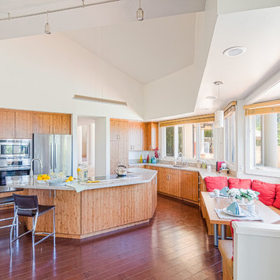 Inspiration for a large contemporary u-shaped dark wood floor eat-in kitchen remodel in Hawaii with flat-panel cabinets, stainless steel appliances, an island, an undermount sink, light wood cabinets and solid surface countertops