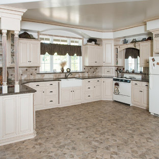 Photo of a mid-sized traditional u-shaped eat-in kitchen in Philadelphia with a farmhouse sink, louvered cabinets, beige cabinets, granite benchtops, beige splashback, mosaic tile splashback, linoleum floors, no island and beige floor.