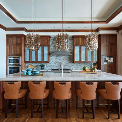Kitchen - mid-sized tropical l-shaped medium tone wood floor and brown floor kitchen idea in Miami with an undermount sink, medium tone wood cabinets, quartz countertops, mosaic tile backsplash, stainless steel appliances, an island, shaker cabinets and gray backsplash