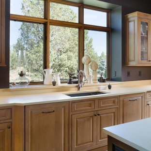 Example of a mountain style kitchen design in Portland with raised-panel cabinets