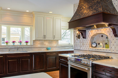 Elegant kitchen photo in Chicago with raised-panel cabinets, quartz countertops and mosaic tile backsplash