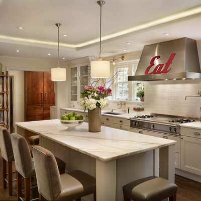 Inspiration for a timeless l-shaped eat-in kitchen remodel in Philadelphia with subway tile backsplash, recessed-panel cabinets, white cabinets, white backsplash, an undermount sink and stainless steel appliances