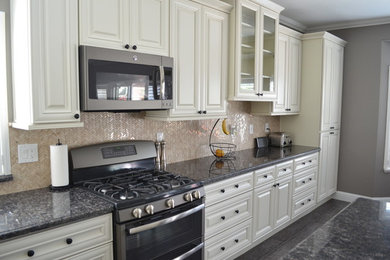 Large trendy l-shaped ceramic tile eat-in kitchen photo in Sacramento with a double-bowl sink, raised-panel cabinets, white cabinets, granite countertops, beige backsplash, mosaic tile backsplash, stainless steel appliances and an island