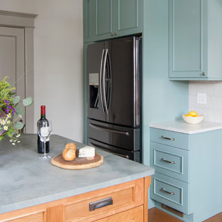 Design ideas for a mid-sized country l-shaped separate kitchen in Chicago with an undermount sink, recessed-panel cabinets, green cabinets, quartz benchtops, grey splashback, porcelain splashback, stainless steel appliances, cork floors, a peninsula and brown floor.