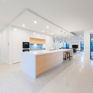 Large contemporary kitchen pantry inspiration - Example of a large trendy galley terrazzo floor kitchen pantry design in Canberra - Queanbeyan with an undermount sink, flat-panel cabinets, white cabinets, solid surface countertops, blue backsplash, glass sheet backsplash, stainless steel appliances and an island