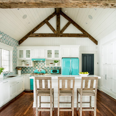 Example of a small country l-shaped medium tone wood floor open concept kitchen design in St Louis with white cabinets, colored appliances, an island, an undermount sink, beaded inset cabinets, quartz countertops, multicolored backsplash and mosaic tile backsplash