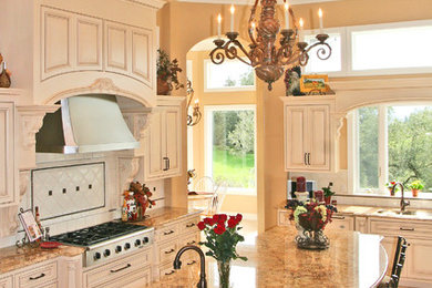 Design ideas for a large traditional u-shaped kitchen in San Francisco with beaded cabinets, an island, a double-bowl sink, white cabinets, granite worktops, stainless steel appliances, travertine flooring and multi-coloured splashback.