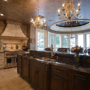 Mid-sized mediterranean eat-in kitchen ideas - Mid-sized tuscan l-shaped travertine floor eat-in kitchen photo in Cleveland with a double-bowl sink, recessed-panel cabinets, an island, beige cabinets, solid surface countertops and paneled appliances