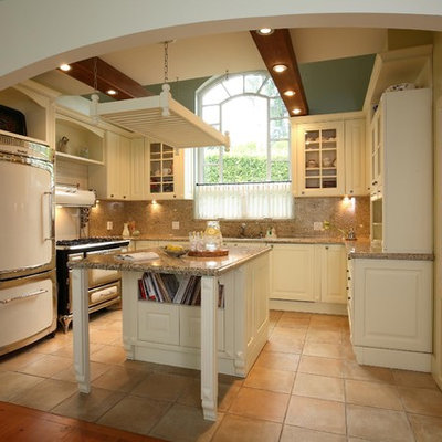 Tuscan u-shaped kitchen photo in Vancouver with glass-front cabinets, white cabinets, brown backsplash and white appliances