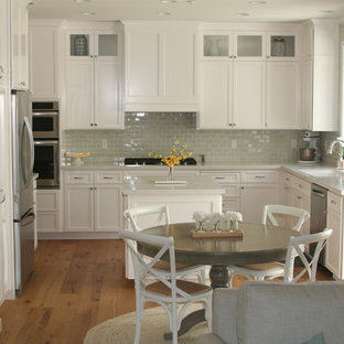 Transitional kitchen ideas - Kitchen - transitional medium tone wood floor kitchen idea in Other with an undermount sink, recessed-panel cabinets, white cabinets, quartz countertops, blue backsplash, subway tile backsplash, stainless steel appliances and an island