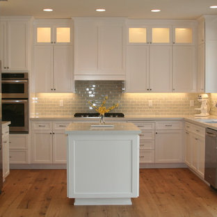 Transitional open concept kitchen remodeling - Inspiration for a transitional u-shaped medium tone wood floor open concept kitchen remodel in San Luis Obispo with an undermount sink, shaker cabinets, white cabinets, quartz countertops, blue backsplash, porcelain backsplash, stainless steel appliances and an island