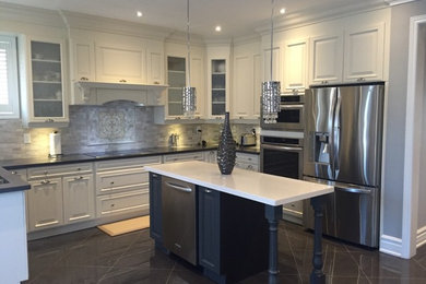 Mid-sized elegant u-shaped ceramic tile eat-in kitchen photo in Toronto with a double-bowl sink, raised-panel cabinets, white cabinets, quartz countertops, beige backsplash, stone tile backsplash, stainless steel appliances and an island