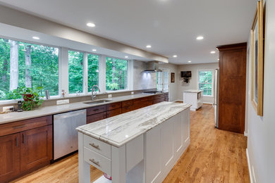 Kitchen - large transitional galley medium tone wood floor kitchen idea in DC Metro with an undermount sink, shaker cabinets, quartz countertops, stainless steel appliances and two islands