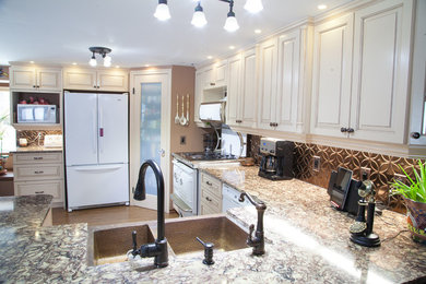 Inspiration for a mid-sized transitional u-shaped light wood floor and beige floor open concept kitchen remodel in Other with a double-bowl sink, raised-panel cabinets, beige cabinets, metallic backsplash, white appliances and a peninsula