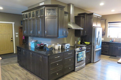 Open concept kitchen - large transitional l-shaped light wood floor open concept kitchen idea in Other with gray cabinets, quartz countertops, stainless steel appliances, an island, a triple-bowl sink and shaker cabinets