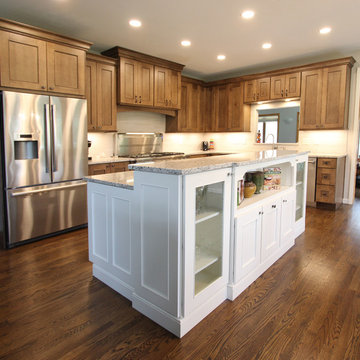 Two Toned Kitchen with White Island and Great Room Stacked Stone Fireplace