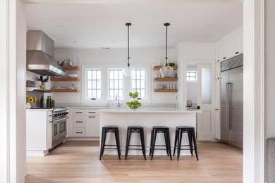 Open concept kitchen - mid-sized contemporary u-shaped light wood floor and beige floor open concept kitchen idea in Seattle with an island, an undermount sink, shaker cabinets, white cabinets, quartzite countertops and stainless steel appliances