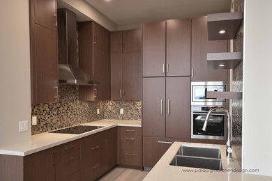 Example of a mid-sized trendy l-shaped light wood floor eat-in kitchen design in Vancouver with an undermount sink, flat-panel cabinets, dark wood cabinets, quartzite countertops, multicolored backsplash, glass tile backsplash, stainless steel appliances and a peninsula