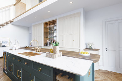 Large modern l-shaped enclosed kitchen in Other with a built-in sink, shaker cabinets, blue cabinets, marble worktops, white splashback, marble splashback, coloured appliances, light hardwood flooring, an island, brown floors and white worktops.