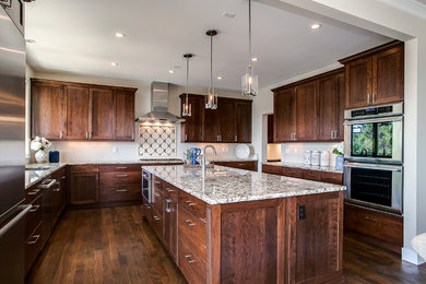 Inspiration for a large transitional u-shaped dark wood floor open concept kitchen remodel in Other with an undermount sink, shaker cabinets, dark wood cabinets, granite countertops, beige backsplash, stone tile backsplash, stainless steel appliances and an island