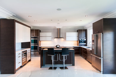 Example of a large minimalist l-shaped porcelain tile eat-in kitchen design in Toronto with an undermount sink, flat-panel cabinets, dark wood cabinets, solid surface countertops, white backsplash, porcelain backsplash, stainless steel appliances and an island