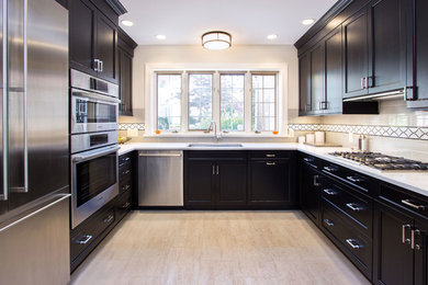 Large trendy l-shaped enclosed kitchen photo in Philadelphia with an undermount sink, recessed-panel cabinets, black cabinets, quartzite countertops, multicolored backsplash, ceramic backsplash, stainless steel appliances and no island