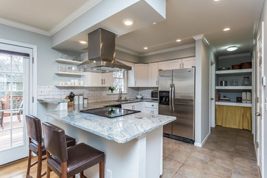 Eat-in kitchen - mid-sized transitional l-shaped porcelain tile eat-in kitchen idea in Atlanta with shaker cabinets, white cabinets, a peninsula, an undermount sink, marble countertops, white backsplash, subway tile backsplash and stainless steel appliances