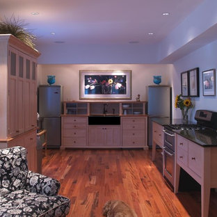 Inspiration for a modern u-shaped kitchen remodel in Philadelphia with a farmhouse sink, light wood cabinets, granite countertops and paneled appliances