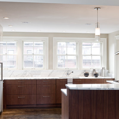 Inspiration for a contemporary u-shaped kitchen remodel in Boston with stainless steel appliances, marble countertops, flat-panel cabinets, dark wood cabinets and marble backsplash