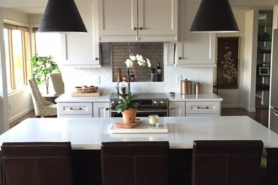 Example of a large transitional eat-in kitchen design in Seattle with recessed-panel cabinets, white cabinets, quartzite countertops and an island