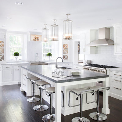 Transitional kitchen photo in New York with a farmhouse sink, shaker cabinets, white cabinets, concrete countertops, white backsplash, mosaic tile backsplash and stainless steel appliances