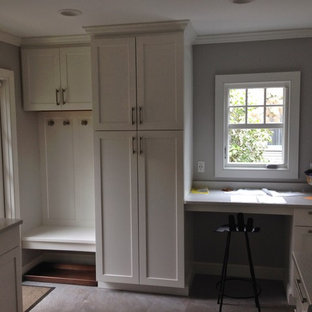 This is an example of a small traditional l-shaped eat-in kitchen in Boston with a double-bowl sink, shaker cabinets, white cabinets, quartz benchtops, stainless steel appliances, slate floors and no island.