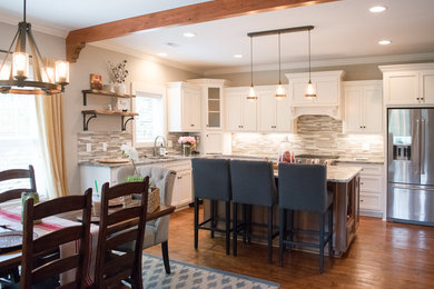 Inspiration for a mid-sized craftsman l-shaped kitchen remodel in Other with a farmhouse sink, stainless steel appliances and an island