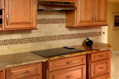 Elegant l-shaped beige floor open concept kitchen photo in San Diego with a farmhouse sink, beaded inset cabinets, medium tone wood cabinets, beige backsplash, stainless steel appliances and a peninsula