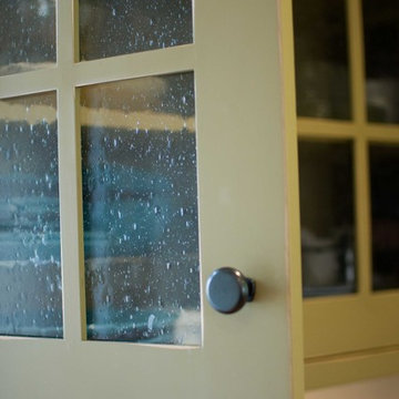 Upper corner cabinet with Seedy Glass, paint SW7731 San Antionio Sage.