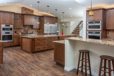 Inspiration for a huge craftsman vinyl floor and brown floor eat-in kitchen remodel in Other with an undermount sink, shaker cabinets, medium tone wood cabinets, quartz countertops, brown backsplash, ceramic backsplash, stainless steel appliances, two islands and multicolored countertops